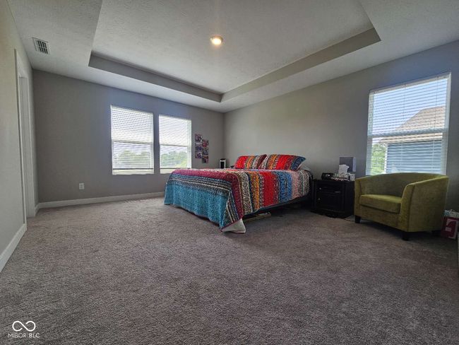 bedroom with a tray ceiling, carpet flooring, and baseboards | Image 17