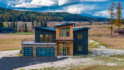 Modern home with a mountain view, a garage, and a balcony | Image 1