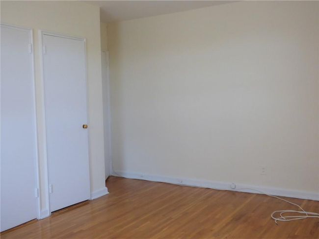 Bedroom featuring baseboards and light wood-style floors | Image 18