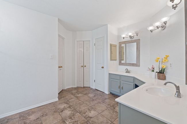 Bathroom with double vanity, stone finish floors, and a closet | Image 20