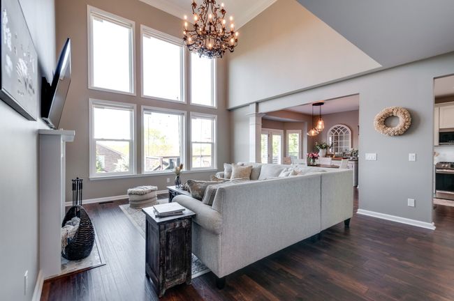 The 2-story generously spaced living room has a wall of windows overlooking the hills of south Nashville and Brentwood! The windows are outfitted with motorized remote controlled solar powered shades. | Image 11