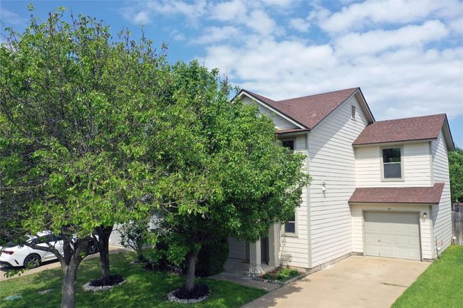 View of front facade with an attached garage, roof with shingles, driveway, and a front lawn | Image 29