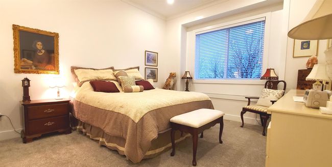 Bedroom featuring baseboards, crown molding, and light carpet | Image 26