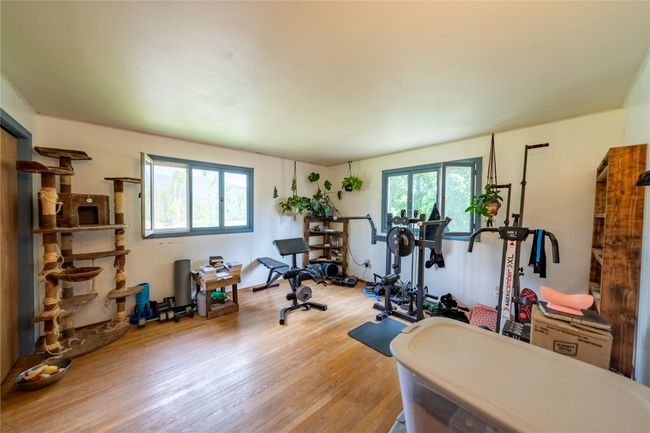 Exercise room with healthy amount of natural light and wood finished floors | Image 44