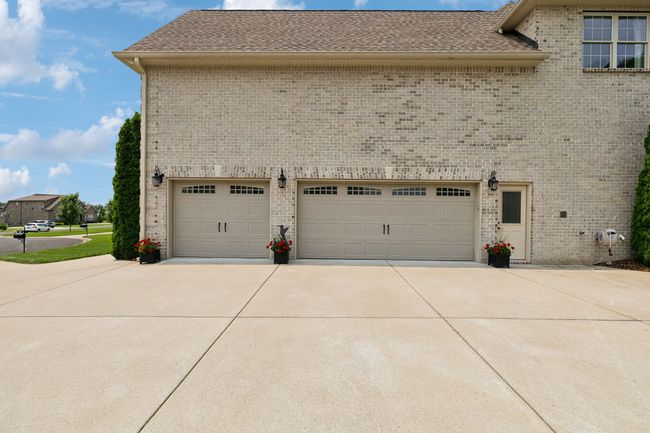 Plenty of room for parking and turn around in this spacious driveway. Owner upgraded the amount of concrete for added convenience. | Image 62