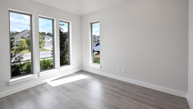 Spare room featuring baseboards and wood finished floors | Image 12