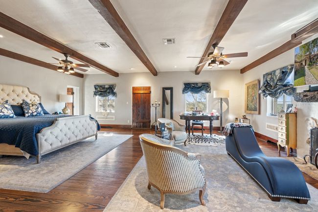 Bedroom featuring wood finished floors, baseboards, multiple windows, and visible vents | Image 17