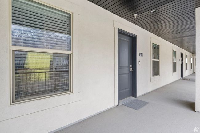 Doorway to property with stucco siding | Image 8