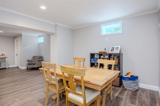 Dining space with wood finished floors, crown molding, and recessed lighting | Image 31