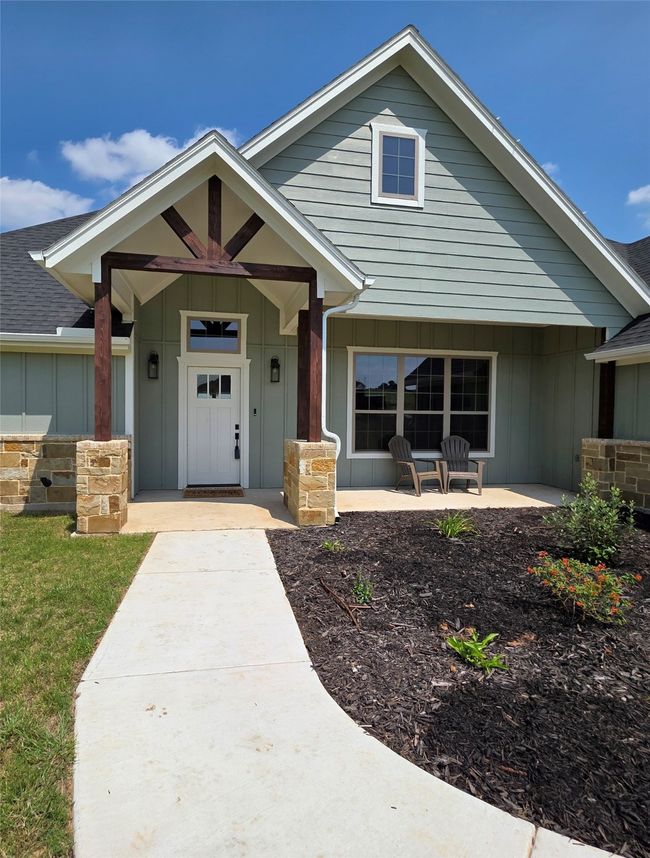 View of front of house featuring board and batten siding and covered porch | Image 4