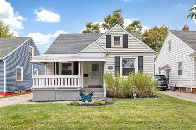 Bungalow-style house featuring a front lawn and covered porch | Image 1