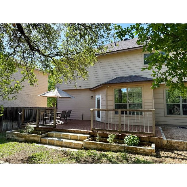 Rear of house has large deck and great stone planters | Image 9