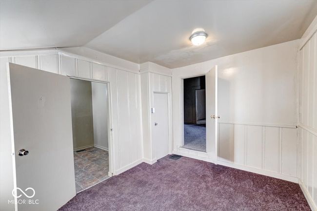 unfurnished bedroom with carpet and a decorative wall | Image 13