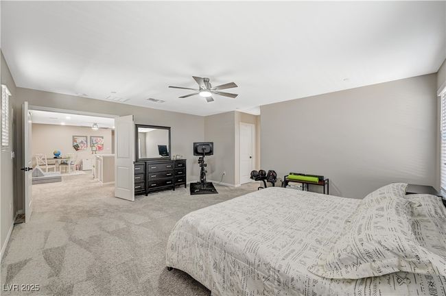 Carpeted bedroom featuring a ceiling fan and baseboards | Image 38