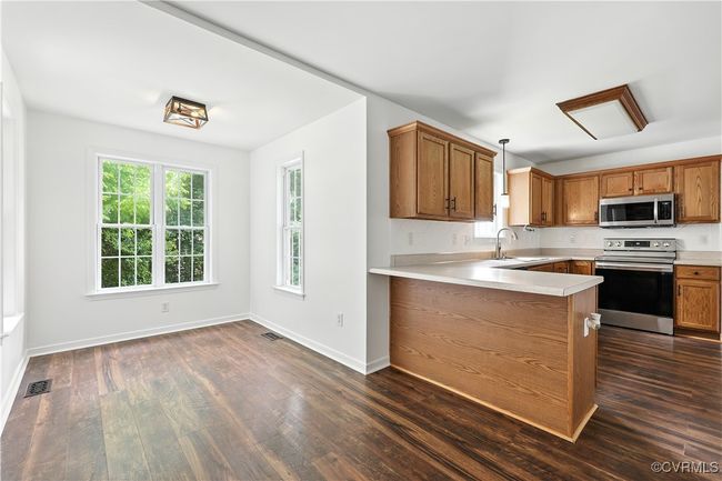 Kitchen featuring appliances with stainless steel finishes and light countertops | Image 8