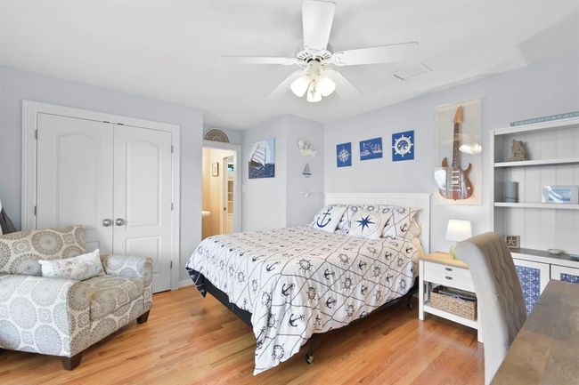 This second bedroom offers direct access to the upper porch and stunning lakefront views. | Image 31