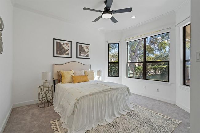 Main floor guest suite, ideal for multi-generational living. Featuring a bay window, plush carpet, and neutral finishes, this suite creates a welcoming and serene atmosphere. | Image 26