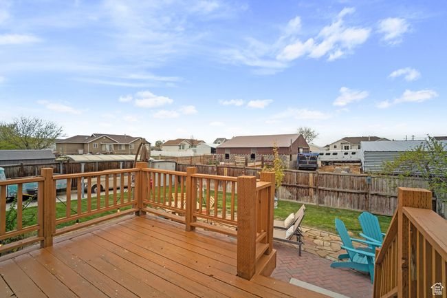 Deck featuring a lawn, a fenced backyard, a residential view, and a patio area | Image 28