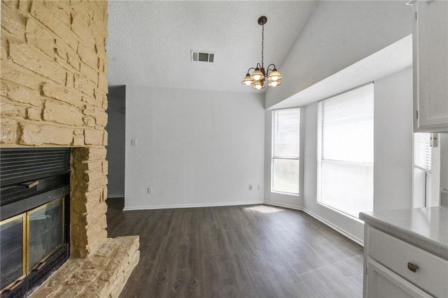 Two-sided fireplace in dining area and kitchen. | Image 6