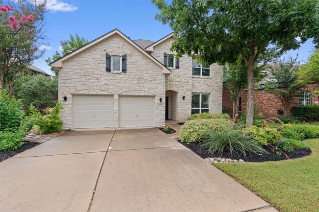 View of front of property with stone siding, an attached garage, and driveway | Image 37