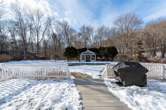 Oversized deck overlooking level, fenced backyard, pool and pool gazebo. | Image 27