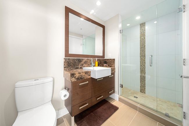 Bathroom featuring vanity, a stall shower, recessed lighting, backsplash, and tile patterned flooring | Image 21