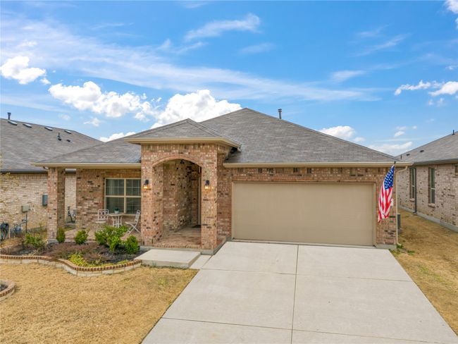 View of front of property featuring brick siding, an attached garage, concrete driveway, and roof with shingles | Image 29