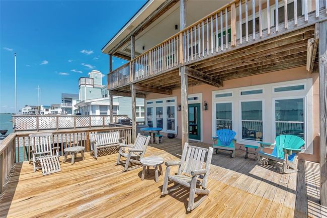 The lower deck is spacious and set up with chairs and tables, giving you a great place to relax right by the water. | Image 37