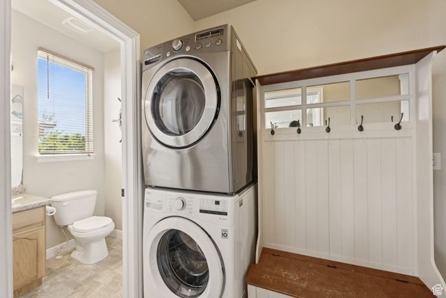 Washroom featuring stacked washer and clothes dryer and baseboards | Image 18
