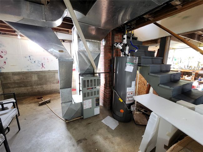 Utilities featuring heating unit and gas water heater | Image 42