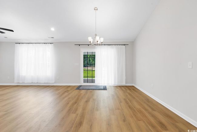 Unfurnished room featuring a chandelier, light wood-type flooring, baseboards, a ceiling fan, and recessed lighting | Image 28