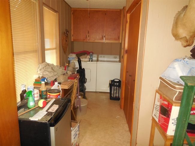 Large laundry area with storage. | Image 11