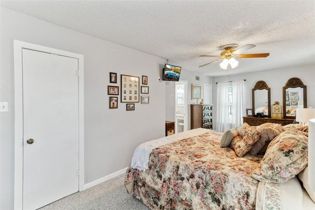 Primary bedroom features a full ensuite bathroom along with two closets, including a generously sized walk-in closet for ample storage. | Image 12