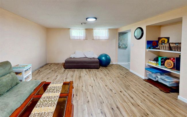 View of property exterior featuring an attached garage, driveway, and stucco siding | Image 42