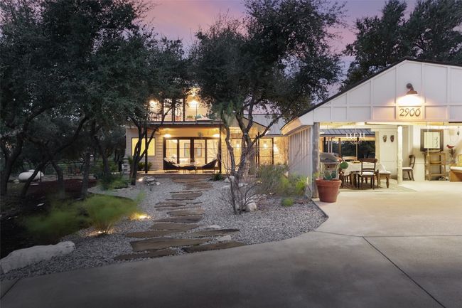 Side of house at dusk with a patio area and open garage, Zen landscaped area and circular drive | Image 10