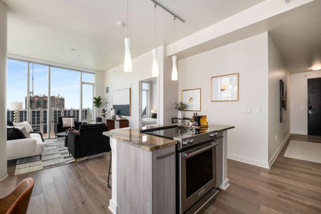Back inside, enjoy the partnership of open-concept living with the backdrop of captivating city views. | Image 17