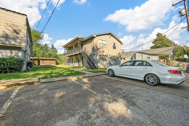 View of front facade with stairway and uncovered parking | Image 14