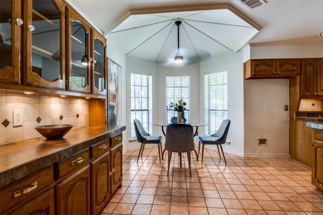 Dining room featuring crown molding and light tile patterned floors | Image 7
