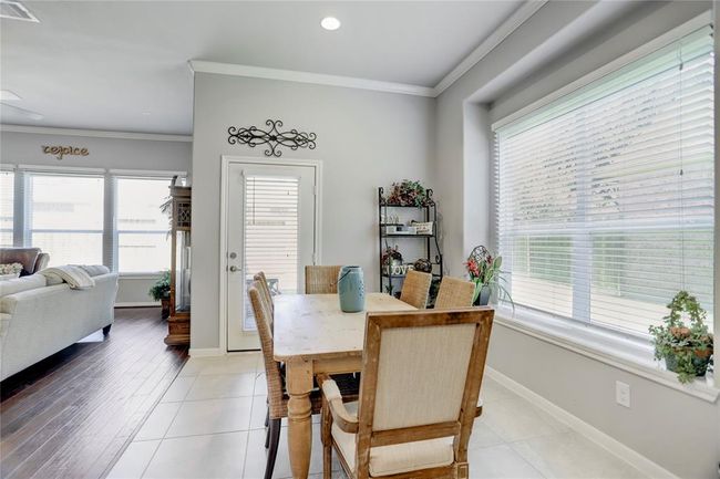 This bright breakfast room is adjacent to the kitchen and overlooks the large living room area. | Image 17