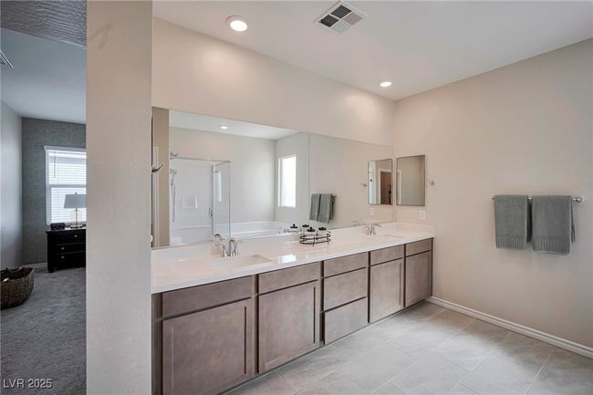 Full bath with baseboards, visible vents, double vanity, and a sink | Image 18