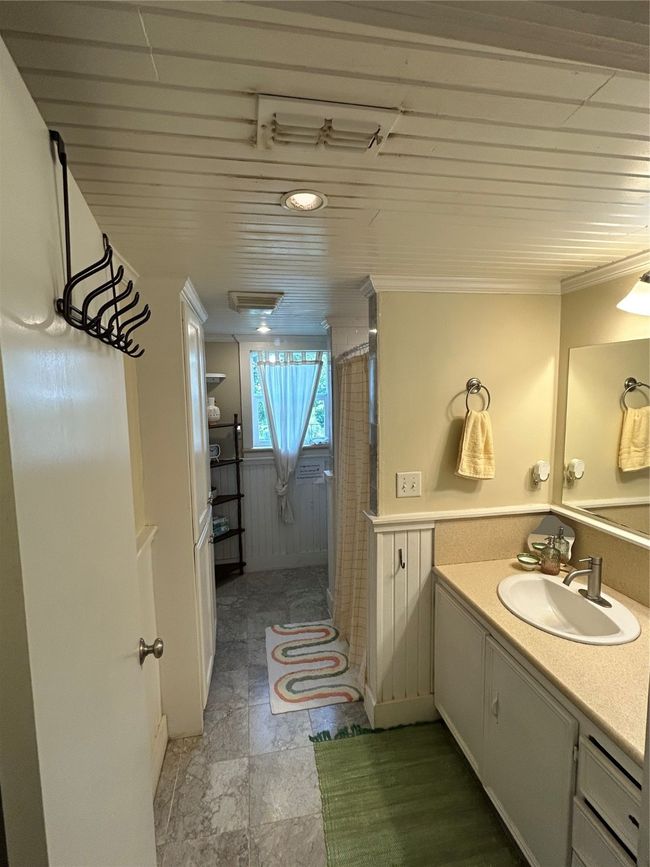 Bathroom with vanity, a shower with curtain, and ornamental molding | Image 20