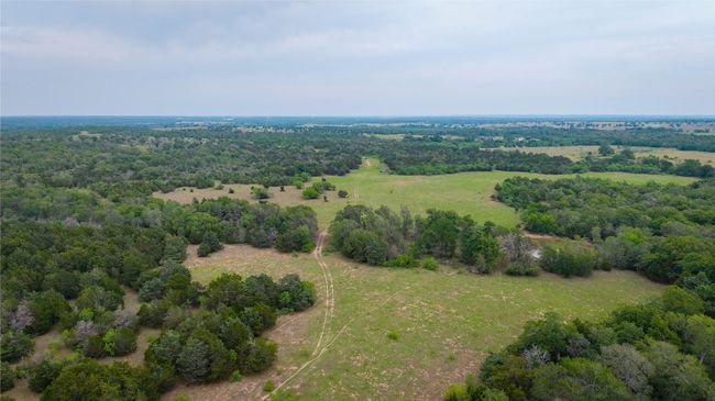Aerial view of property and surrounding area with a forest | Image 10