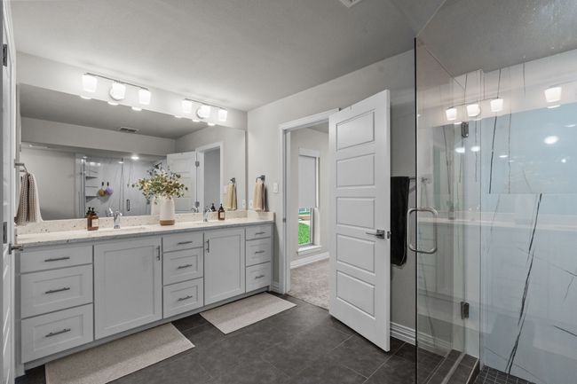 Primary Bathroom featuring double vanities, shower and primary closet | Image 22