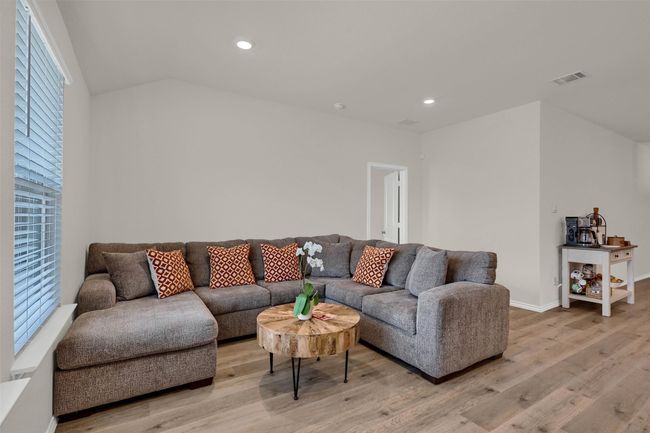 Living room with light wood-style flooring, recessed lighting, and vaulted ceiling | Image 8