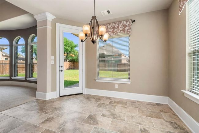 Casual dining area in the kitchen with access to the covered patio. | Image 20