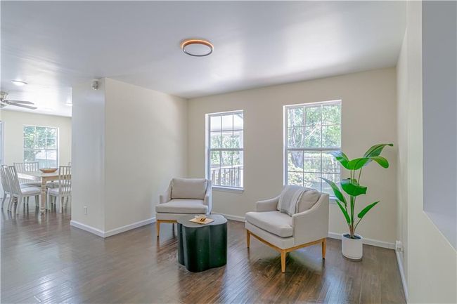 Sitting room with ceiling fan, a wealth of natural light, and dark hardwood / wood-style flooring | Image 19