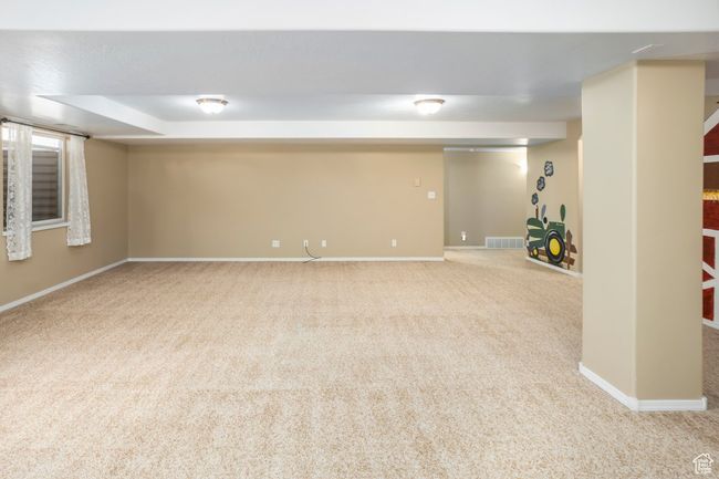 Finished basement featuring baseboards, carpet flooring, and visible vents | Image 31