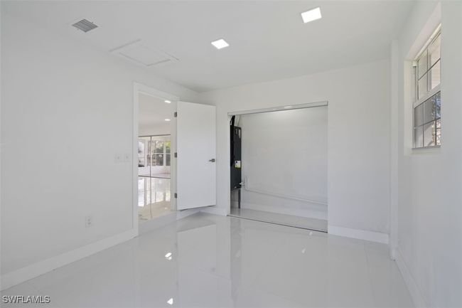 Unfurnished room featuring attic access, visible vents, and baseboards | Image 10