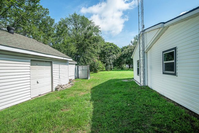 View of grassy yard featuring a garage | Image 25