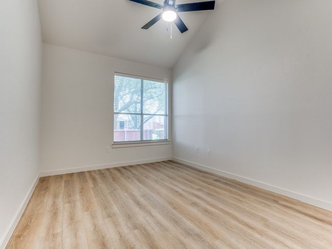 Unfurnished room featuring light wood-style flooring, a ceiling fan, and high vaulted ceiling | Image 15